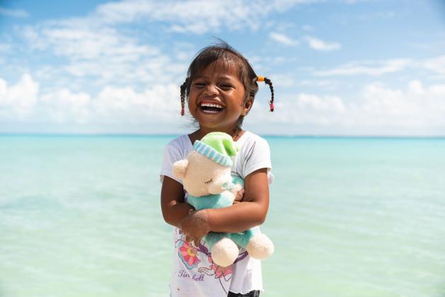 A girl from Kiribati loves the new “wow” toy she found in her shoebox gift.