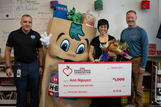 Ann Nguyen (center), a teacher at Round Rock High School, Round Rock ISD, was a finalist in the 2024 H-E-B Excellence in Education Awards. Representatives from H-E-B surprised her with a $1,000 check.