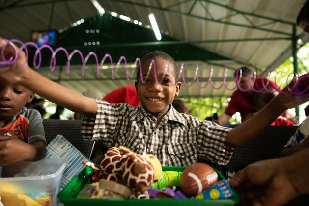 A slinky brings immediate delight to a boy in Antigua.