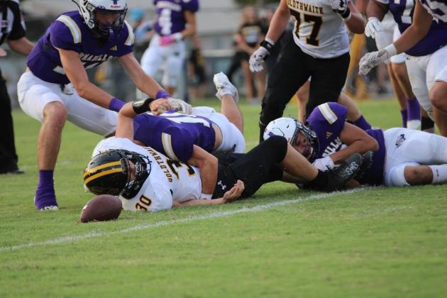 Adrian Martinez and Winton Lackey smother the RB as Levi Glover goes after the fumble. Courtesy of Kayti Lackey - 1916 Athletics