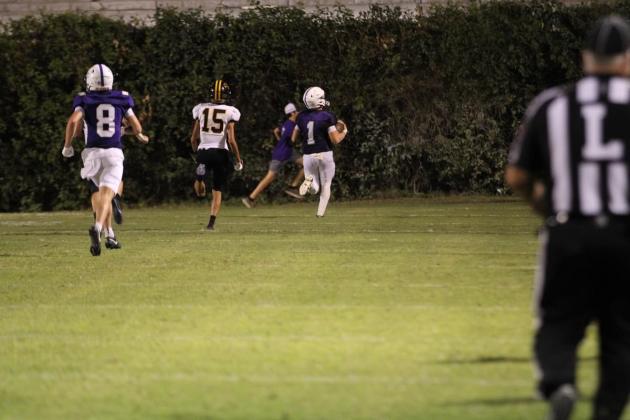 Luke Tharp (#1) races to the end zone. Courtesy of Kayti Lackey - 1916 Athletics