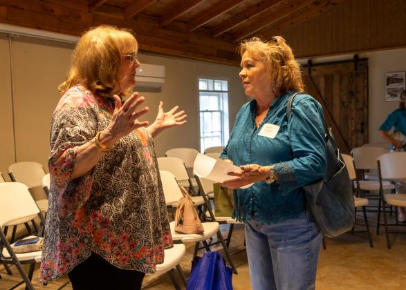Marjean Alexander, Club Treasurer, welcoming new member Juanita Proffitt