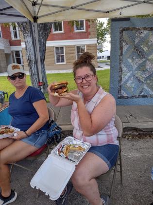 Mary Ferris showing off her Patron Burger from Pepperbelly's