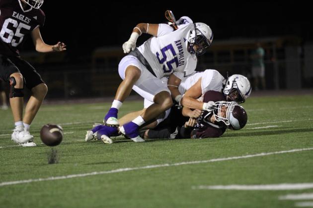 San Saba’s Danny English and Adrian Martinez (55) force a fumble. Photo courtesy of Kayti lackey - 1916 athletics