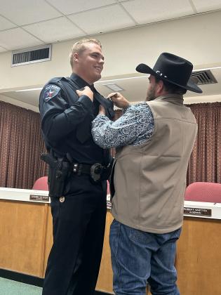 Steven being pinned by his father, Steve Haviland, at the City Hall swearing in