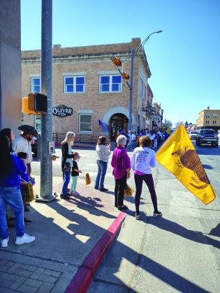 Community gathering at the corner of Wallace St. and Hwy 16 waiting for the Lady Dillos' bus