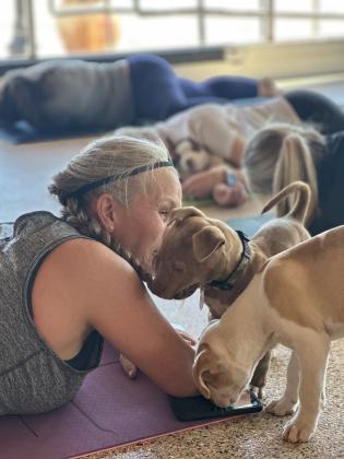 Yoga instructor Daneen Scott loving on her pup | photo courtesy of Regina Baker