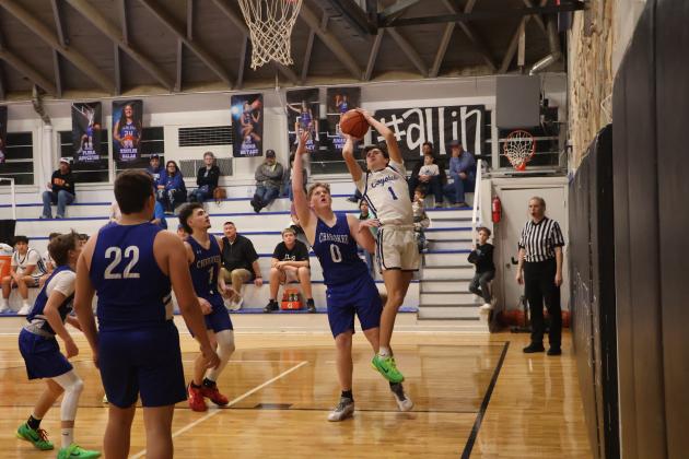 # 1 Hutton Rogers stretching in whatever way is necessary as he goes up for or a 2 in last week's win over Cherokee. Courtesy of Pam Starr