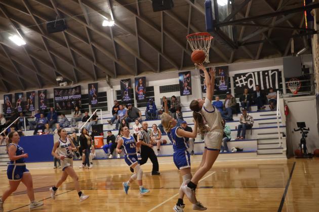#1 Paige Bailey is reaching for the basket in last week's game against Cherokee, and #2 Emma Bryant is also seen in the background Courtesy of Pam Starr