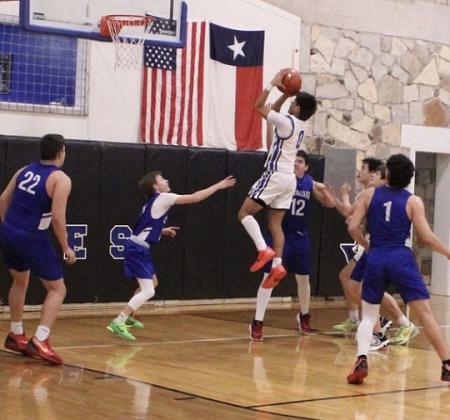 #0 EJ Aviles floats high above his opponents in a fast-paced game against the Cherokee Indians Friday night. Courtesy of Richland Springs Coyote Booster Club