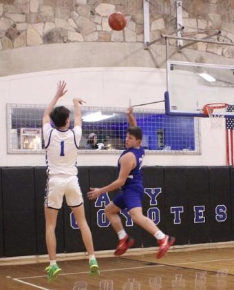 #1 Hutton Rogers brings the defense off the ground in an attempt to block his 3-point shot in Friday’s game against the Cherokee Indians.  Courtesy of Richland Springs Coyote Booster Club