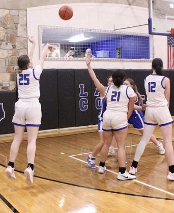 RS #12 Flora Appleton and #21 Amarrea Thomas set their teammate #25 Calyn Kubin up for a wide open 3-pointer to help lead the Lady Coyotes to a BIG WIN over the Cherokee Lady Indians.  Courtesy of Richland Springs Coyote Booster Club