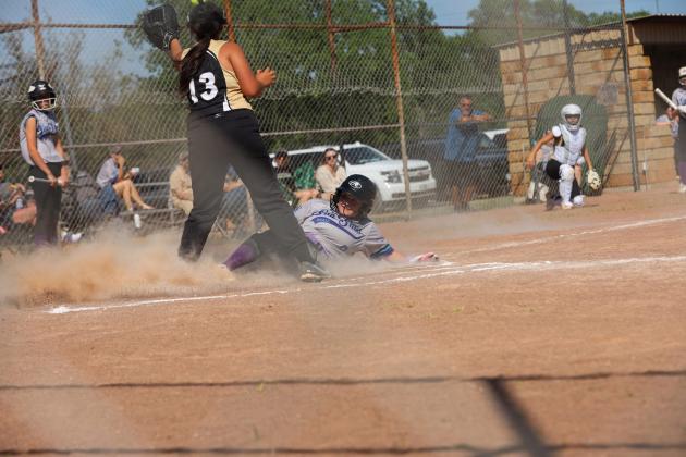 #8 Hanah Sivells slides safely into home contributing to the 15-2 win against Brady