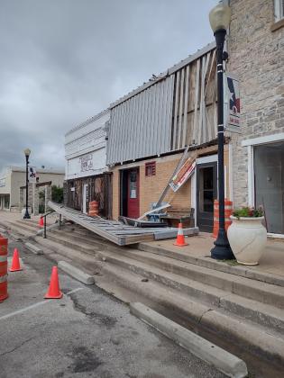 This awning (now on the ground) was on the building between The Daily Mix and Armadillos Iron - right across the street from the Courthouse. | Photo by Djuana Payton