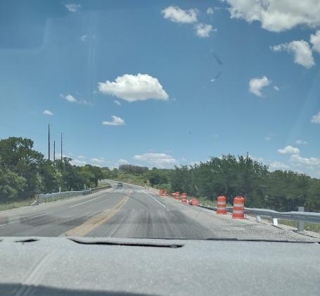 Beautiful, blue sky. But beneath, orange barrier barrels mark the danger spot.