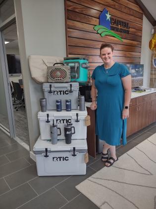 Chamber of Commerce Director Paige Faught standing by some raffle giveaways | Photo by Djuana Payton