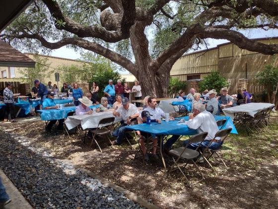 Tables were set up under the trees in this beautiful outdoor setting for the Ribbon Cutting Ceremony.  | Photo by Djuana Payton