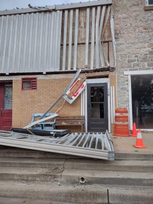 This sign hanging down sign used to be the H&amp;R Block sign that hung above that door, | Photo by Djuana Payton