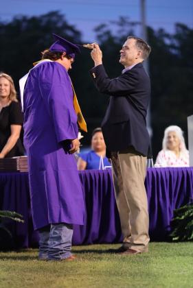 Graduate Stetson Allison has tassel moved to left side by School Board President Kevin Shanan  | Photo by Kayti Lackey