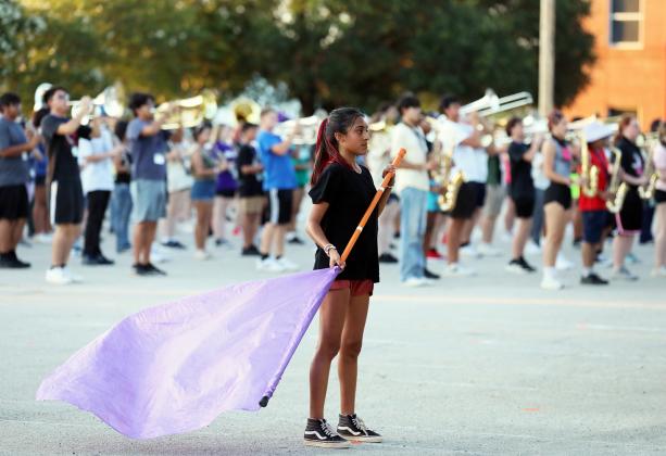 A color guard member develops her skills.
