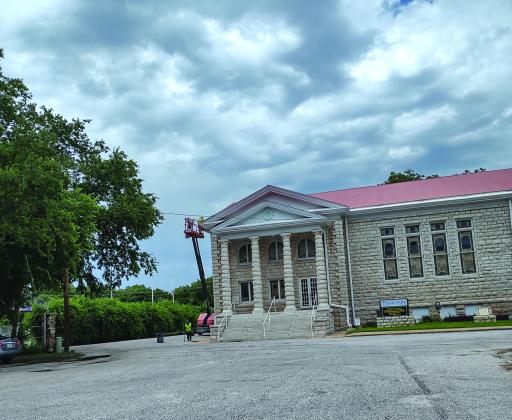 Roofers working on First Methodist Church building on 6-11-25. photo by Djuana Payton