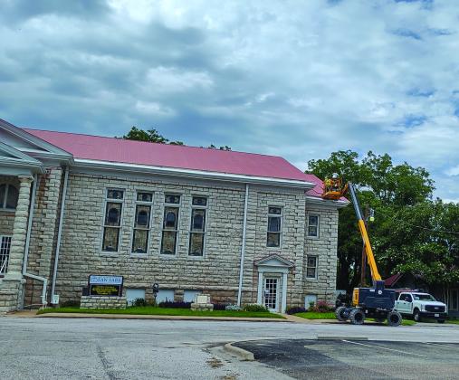 Roofers working on First Methodist Church building on 6-11-25. photo by Djuana Payton