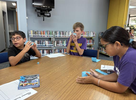 These children are playing a board game at the June 2025 Summer Library Program. Courtesy of Meredith Houck