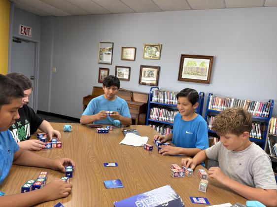 These children are creating an origami cube at the June 2025 Summer Library Program. Courtesy of Meredith Houck