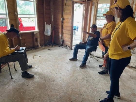 volunteers assess needs of homeowner
