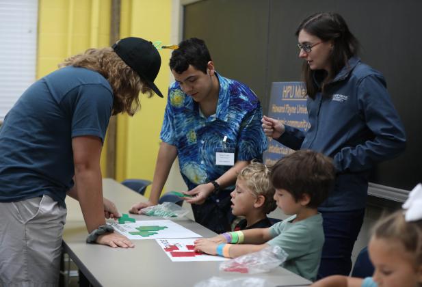 Sarah Langford, assistant professor of mathematics at HPU, assists students with a math activity.