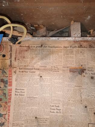 Newspaper covered floor that was uncovered