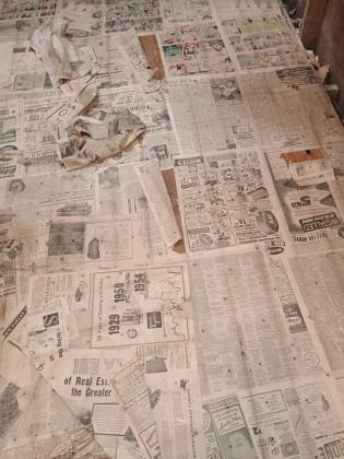 Newspaper covered floor that was uncovered