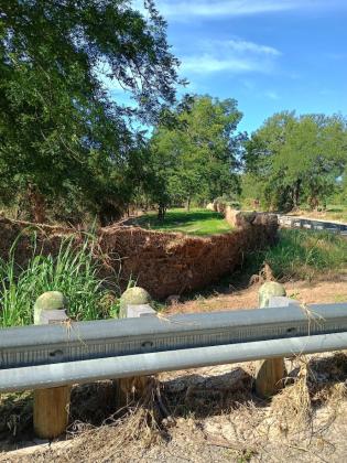 Beyond this guardrail is a 'still standing' fence after the flood waters receded. This is on the way to the Mike Millican's place. | Photo by Djuana Payton