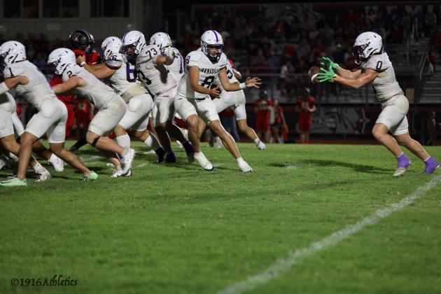 #8 JJ Romero is seen here using his legs to gain yards for the Armadillos in their 17-14 thriller win Friday night against Hamilton.