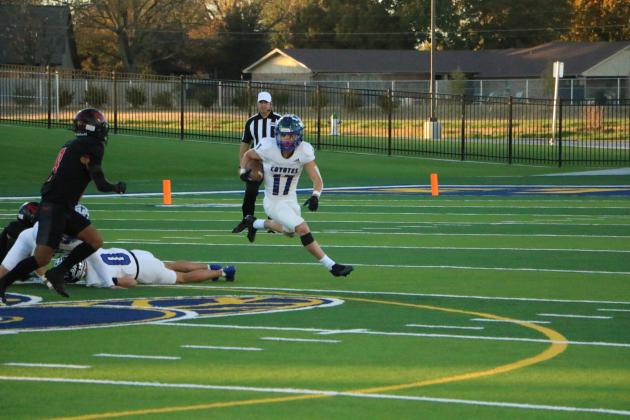 #17 Billy Perry running the ball #0 Cohen Ethridge on the ground