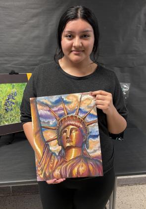 Judy is holding her awarding winning art piece