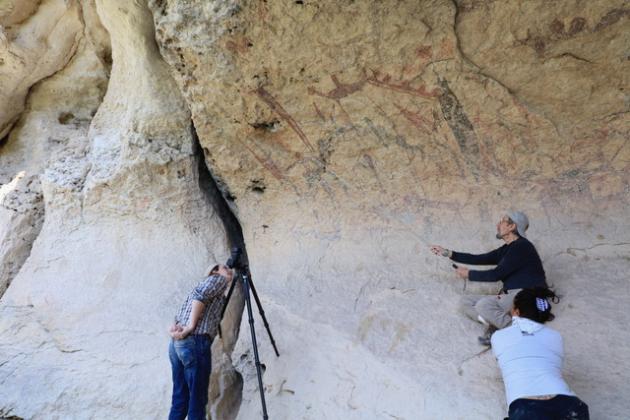 Rock art murals of the Lower Pecos Canyon being examined by a site crew from the Shumla Archaeological Research &amp; Education Center.