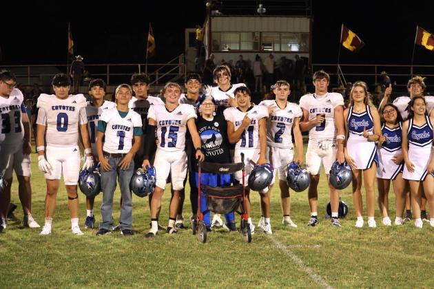 Barbara Young with the Coyote football team