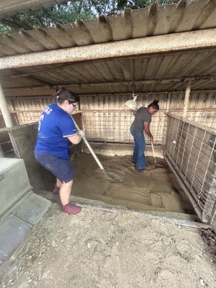Susan and Lisa raking sand