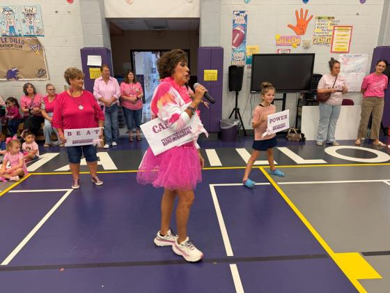 Dora Miller telling our students how important it is to give to our community and help others! Donna Shahan waiting to start the cheering in the background with the help of 4th grader, Paisley Ward.