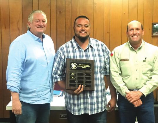 Juan Montoya, Sanitation Supervisor, displays a Supervisor of the Quarter plaque with his name engraved for selection as the City's Supervisor of the Quarter, 2nd Quarter of the year. He also received a gift certificate to a local restaurant. At Juan's right is Alderman Shawn Oliver and to his left is Scott Glaze, Public Works Supervisor, both taking part in the formal presentation.