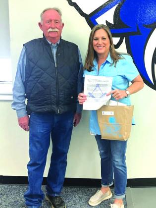 Frank Pearce presenting school supplies to a Richland Springs school representative.