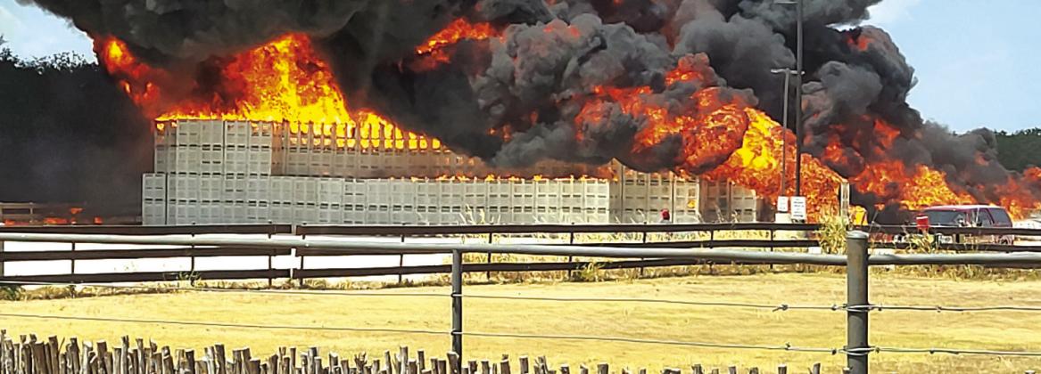 Early on, the flames were very high, and the black smoke could be seen for many miles away. In this picture, you see the empty plastic stroage bins that would soon be completely destroyed by the fire. Photo courtesy of Eduardio Hilario