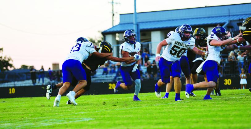 #73 Jose Vega, #2 Graden Lebow, and #50 Kolton Pierce lead and block the way for #1 Luke Tharp in the Battle of the River last Friday.