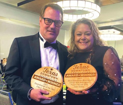 Clay Nettleship with Downtowner of the Year award and Amber Everett with the Best Downtown Business under 50K population award presented to Pecan House Grill.
