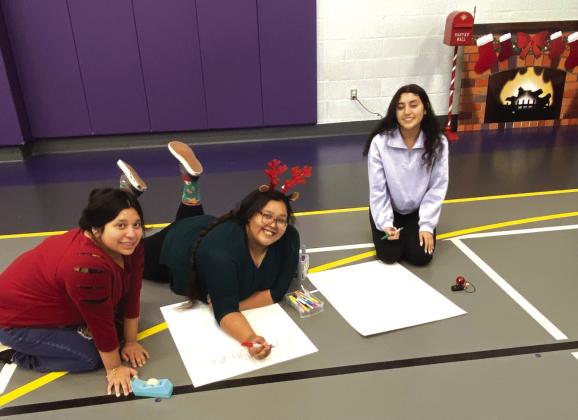 TAFE: Amaya Trevino, Dejah Vasquez and Damaris Patino helping to make Santa's Workshop special for the younger kids!