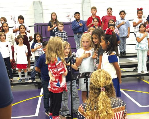Jasmine Vanderburg, Allison Millican, Anlee Boswell, Hadley Fuller, Addilyn Morrison, and Abigail Davila singing the National Anthem