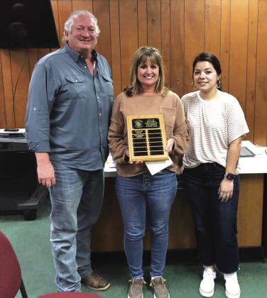 Zane Churchill is proudly displaying the Employee of the Month plaque that now displays here name. She also received a gift certificate to a local restaurant. Alderman Shawn Alederman (left) and Customer Service Billing Coordinator Bridgett Macedo (right) also took part in the presentation. Photo by Scott Glaze