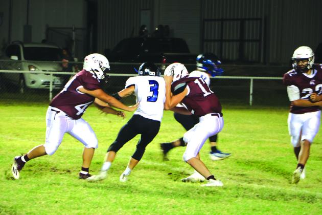 RS Coyote #3 Rush Norris fights off two Lohn Eagles in last Thursday’s game Courtesy of Pam Starr, RSISD