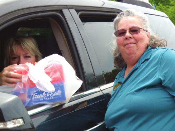 Assistant Manager, Debbie Herd, delivering a tasty meal and a smile to a customer.